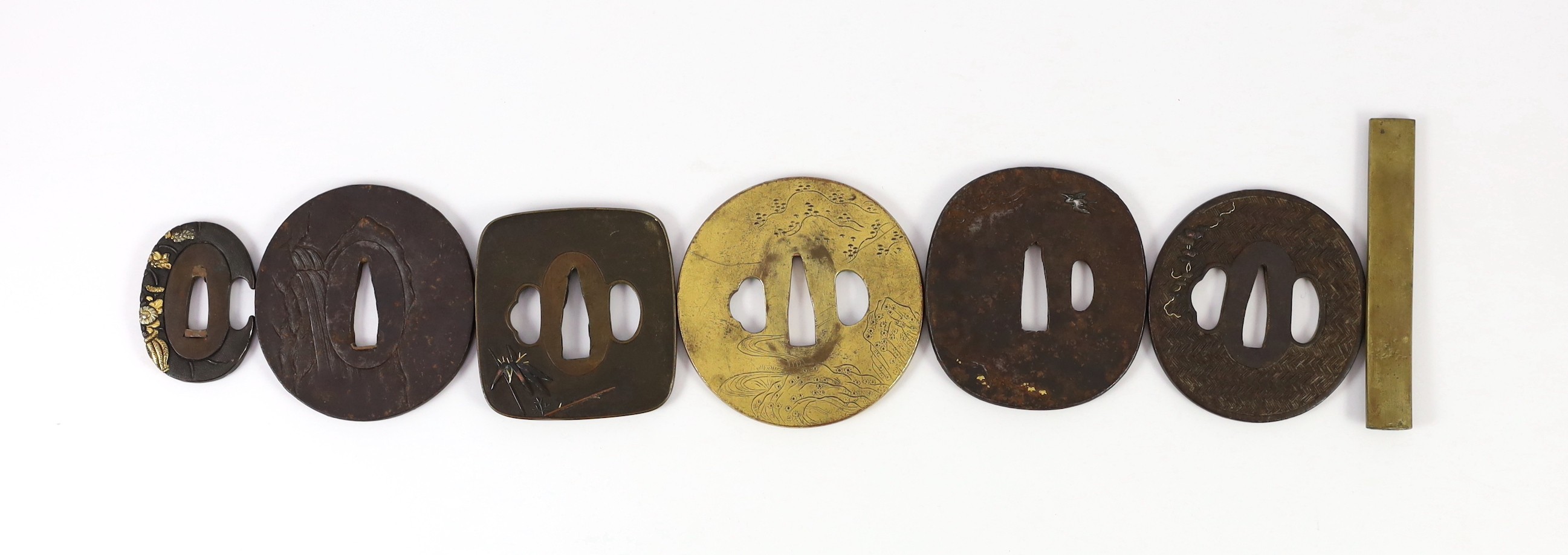 A group of Japanese bronze, iron and mixed metal tsuba and a kozuka knife handle, 19th century